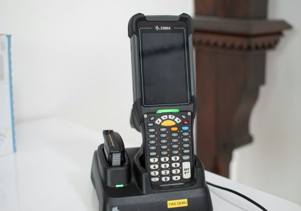 Handheld barcode scanner docked at a charging station, representing the Inventory Sync Pipeline project