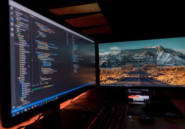 Dual-monitor coding setup at night, representing the Fitness Class Booking App project