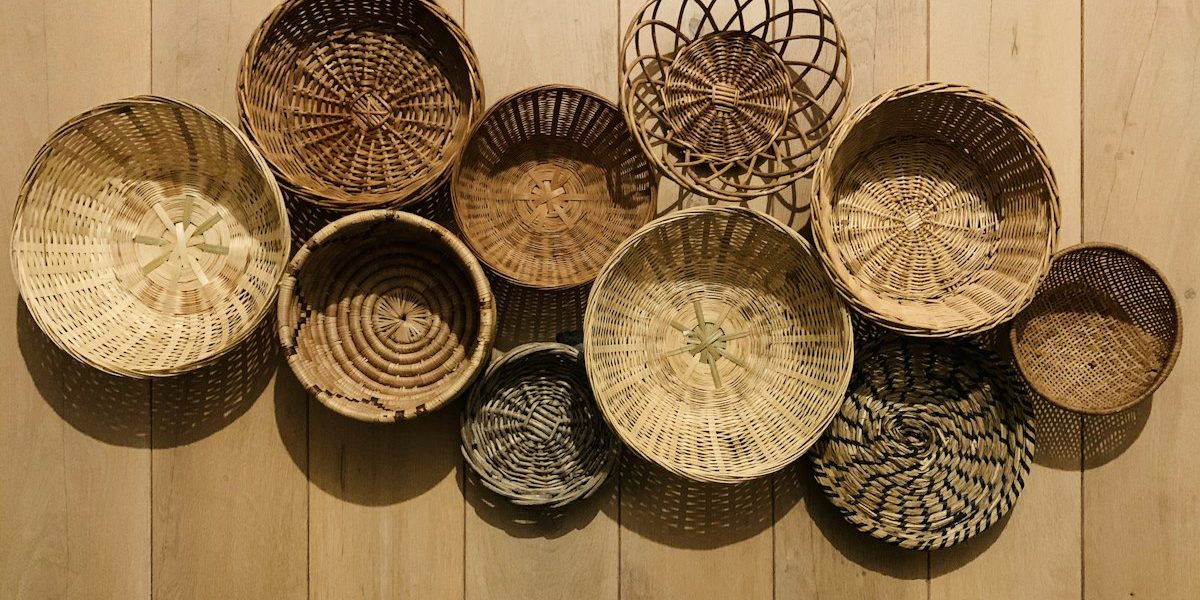 Handwoven baskets displayed on a wooden wall, representing the Tribal Artisan E-Commerce Marketplace project