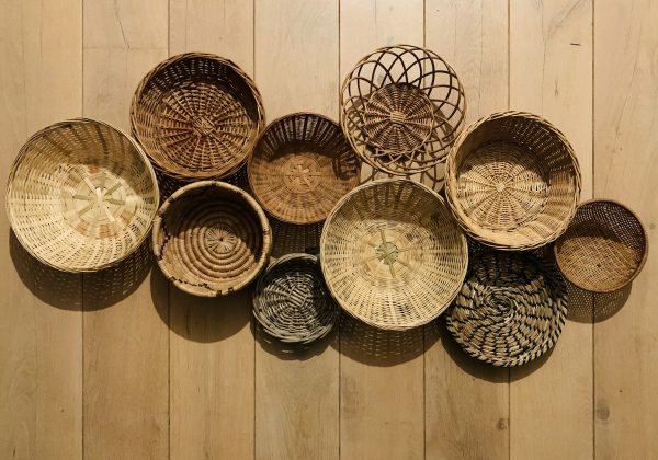 Handwoven baskets displayed on a wooden wall, representing the Tribal Artisan E-Commerce Marketplace project