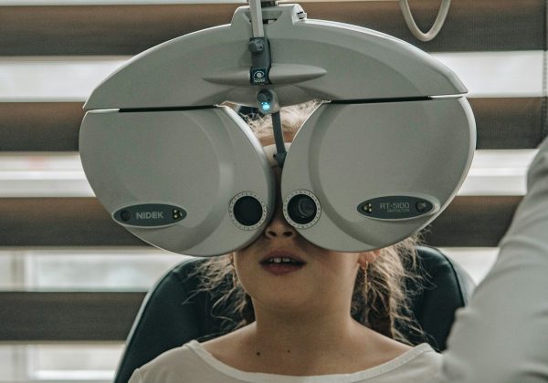 Patient undergoing an eye examination on clinical equipment, representing the Eye Clinic Patient Survey App project